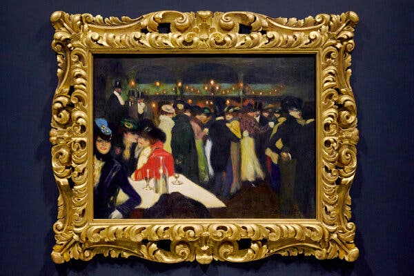 A Picasso painting in an elaborate gold frame and hung on a dark wall. It’s a scene of men and women dressed elegantly, sitting at tables, standing, dancing.